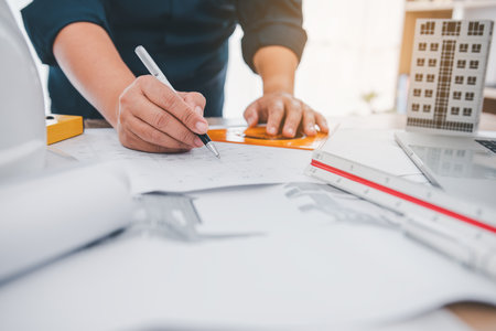 engineer working in office with blueprints, inspection in workplace for architectural plan,...