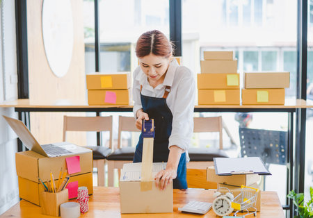 Online small business owners are packing their ordered products into the boxes for their customers...