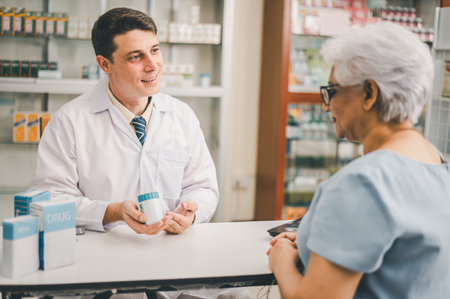 Pharmacist giving advice And advice for patients who come to buy Medicine, Drugs, Vitamins products, according to prescriptions in modern pharmacies.の写真素材