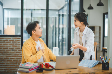 Young students discuss when their work fails and goals are not met.の写真素材