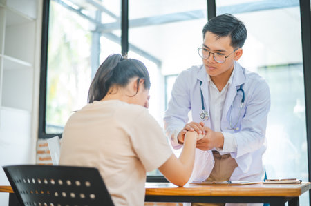 doctor hand holding the patient's hand. To encourage and comfort the patient so that the patient is not sad and worried.の写真素材