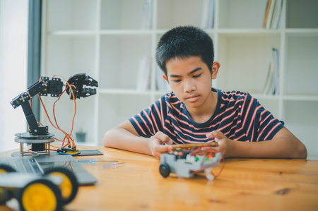 Asian boy learning and studying the work of technology robots.homeschool and science for tech project. playing childhood kids hobby leisure lifestyle people toys robotics technology.の写真素材