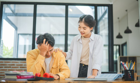 Fellow students are consoling friends who are disappointed in grades, frustrated with tasks that are not meeting their goals, helping each other.の写真素材