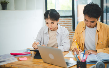young university students consulting doing homework, cooperating research plan Discuss concepts and...