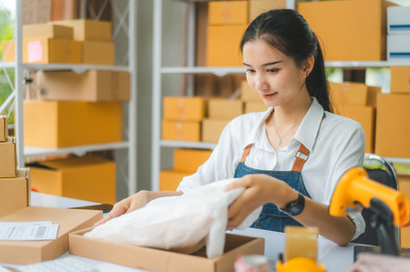 Online small business owners are packing their ordered products that customers order online into a...