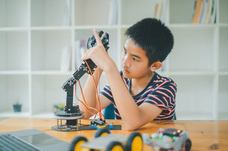 Asian boy learning and studying the work of technology robots.homeschool and science for tech...