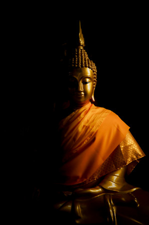 golden buddha in darkの写真素材