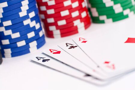 poker chips and playing cards isolated on white