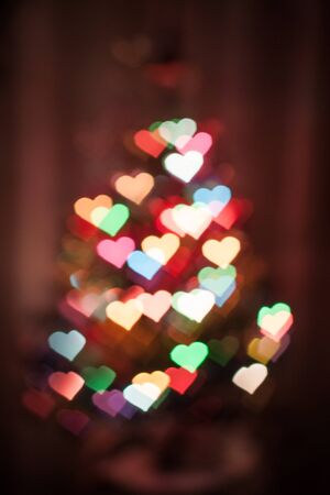 Abstract heart shaped bokeh in the darkの写真素材