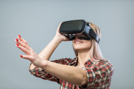 Young cheerful woman with vr headset