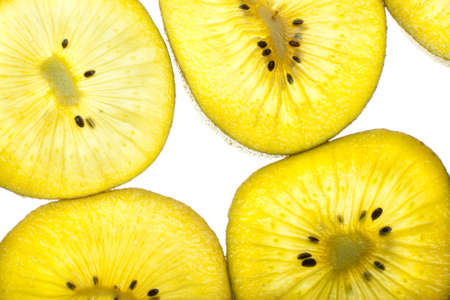 Fresh golden kiwi slices on a gleamの写真素材