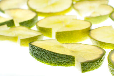 Fresh lime slices on whiteの写真素材