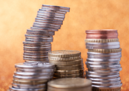 Stacks of coins on golden sparkle background. Financial concept