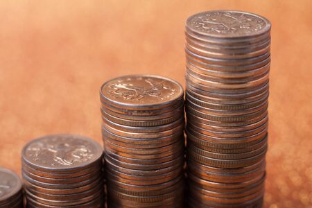 Stacks of coins on golden sparkle background. Financial concept