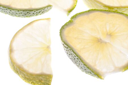 Fresh lime slices on white
