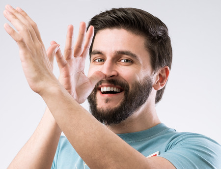 Portrait of cheerful teasing bearded manの写真素材