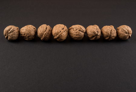 Walnut in shell in line isolated on black. Raw food ingredientsの写真素材