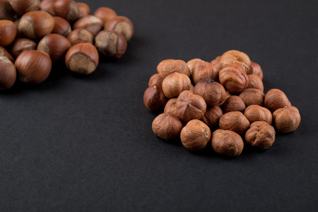 Hazelnuts in shell and kernels isolated on black. Raw food ingredientsの写真素材