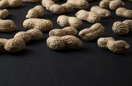 Peanuts in shell isolated on black. Raw food ingredientsの写真素材