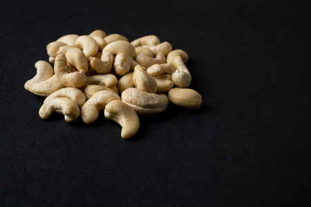 Cashew kernels isolated on black. Raw food ingredientsの写真素材