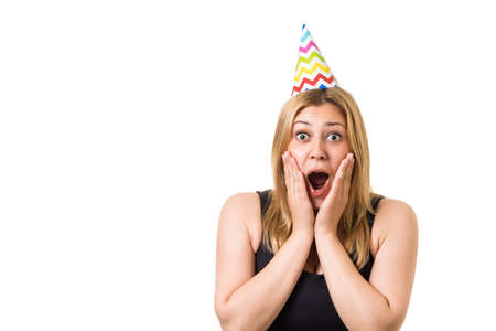 Amazed young beautiful blonde girl holds head in hands on white backgroundの写真素材