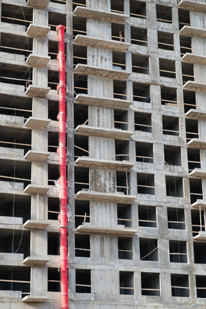 Construction site with a lot of incomplete buildings with cranes. Work in progress. New home in...