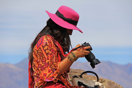 A young lady posing with her camera in Peru 17 Dec 2013 No model release available Editorial use onlyのeditorial素材