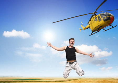 A boy jumps without a parachute from a helicopterの写真素材