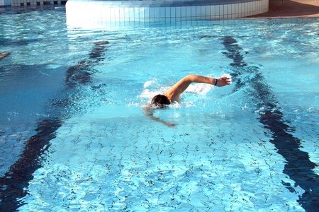 man swims in swimming pool man swims in swimming pool