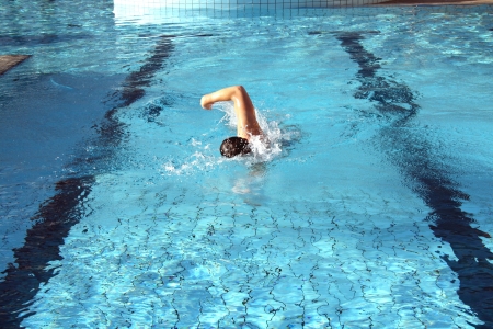 man swims in swimming pool man swims in swimming pool
