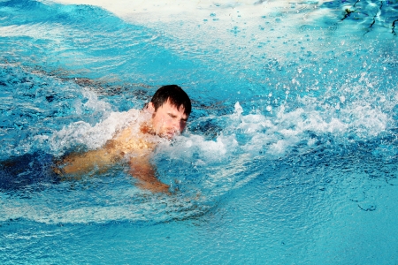 man swims in swimming poolの写真素材