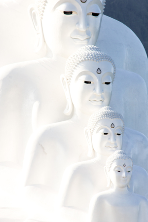 Four size white buddha statue in Temple of Thailand.の写真素材