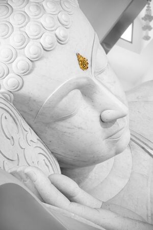 Marble Buddha with golden decoration at forehead.の写真素材