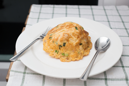 Fries egg, Omelette with onion leaf on plate in Thai style ready to eat.の写真素材
