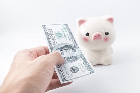 Hand pay money with piggy bank background