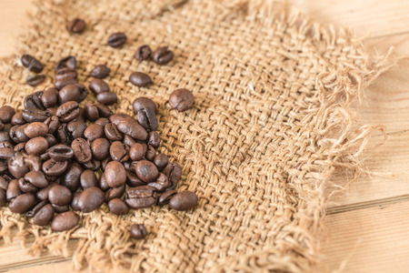 Arabica coffee bean on Sack wood background.の写真素材
