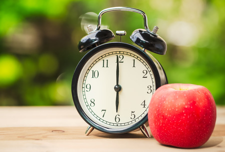 Retro Clock with Morning Fruit Food for First Meal Concept.の写真素材