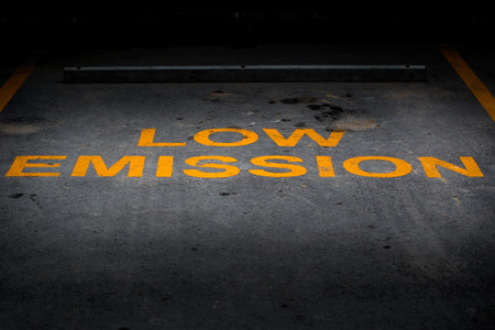 Low Emission yellow word on asphalt parking lot.の写真素材