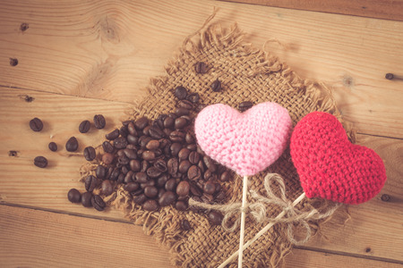 coffee bean with love heart on wood sack backgroundの写真素材