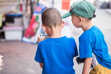 kids play games and carry gun toy, game addict and violence problem.のeditorial素材
