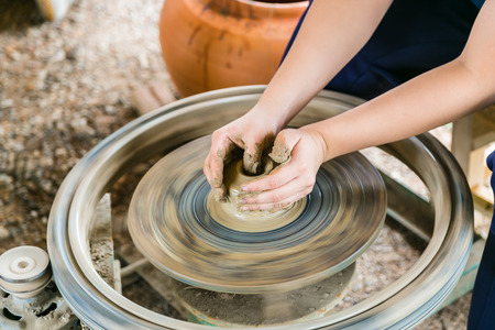 hand making making a clay or mud pot on a potters wheel.の写真素材