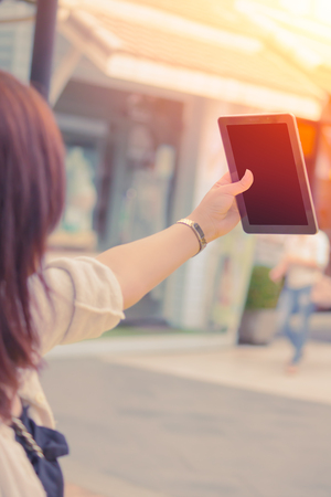 Asian Girl With Hand Holding Tablet for Selfie.の写真素材