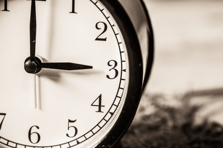 Retro vintage clock on sack closeup at 3 o'clock