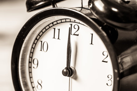 Retro vintage clock on sack closeup at 12 o'clock