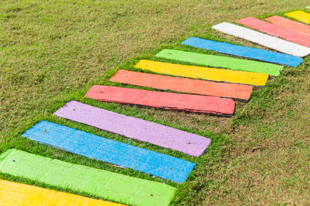 colorful rainbow foot path garden decoration funny park background.の写真素材