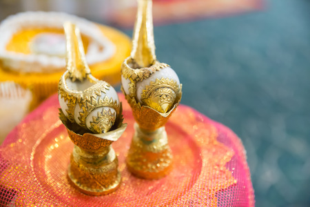 Thai style wedding, Two Golden conch shell use for pour water to married couples hand and bless them to fortune.の写真素材