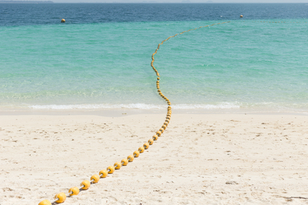 Sea beach with yellow buoys, Safety Swimming zone separator, Thailand ocean travel background.の写真素材