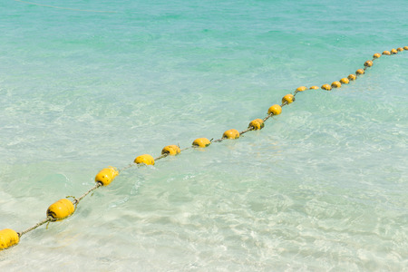 Sea beach with yellow buoys, Safety Swimming zone separator, Thailand ocean travel background.の写真素材