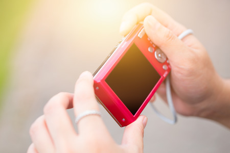 digital compact camera women using outdoorの写真素材