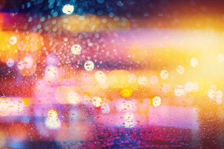 Colorful blur raining night light, colors of nightlife wonderful bokeh background.の写真素材